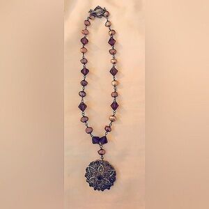 Ornate necklace w/10” strand, round silver flowered pendant,  & earrings.